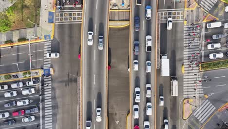 Pedestrian-crossing-road-with-driving-cars-on-intersection-junction