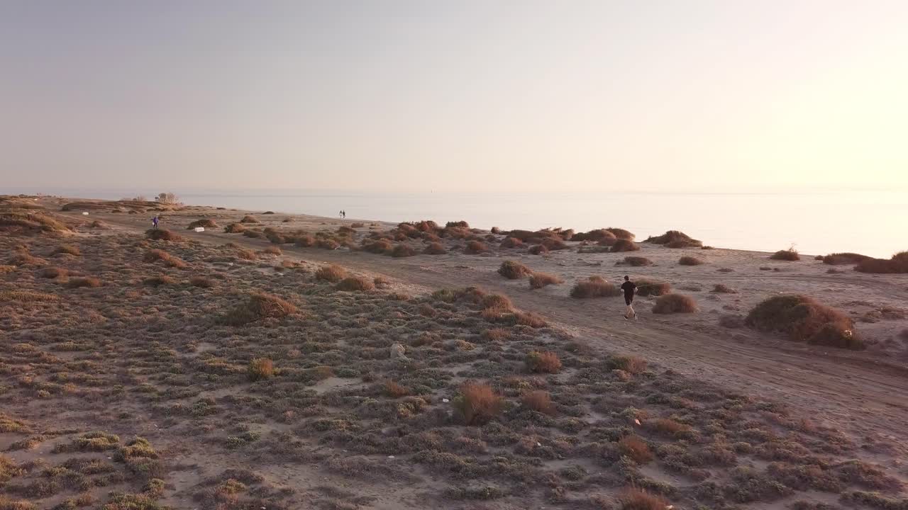 Young man running in the desert landscape