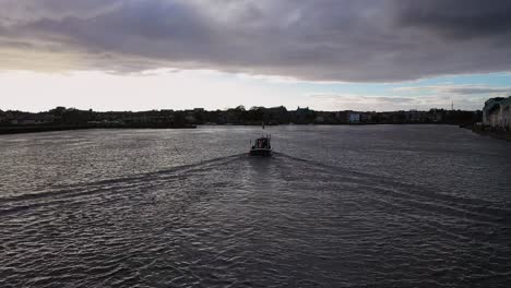 Static-shot-of-a-traditional-Irish-fishing-boat-entering-the-Claddagh-docks-in-Galway,-Ireland