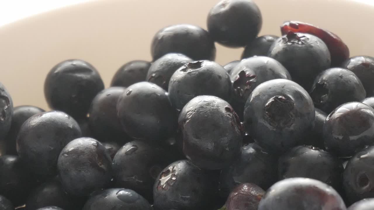 Fresh, juicy blueberries glistening with droplets in a close-up view