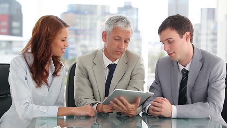 Work-team-looking-at-a-tablet-computer