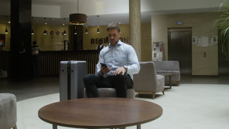 man relaxing on the sofa in the hotel lobby