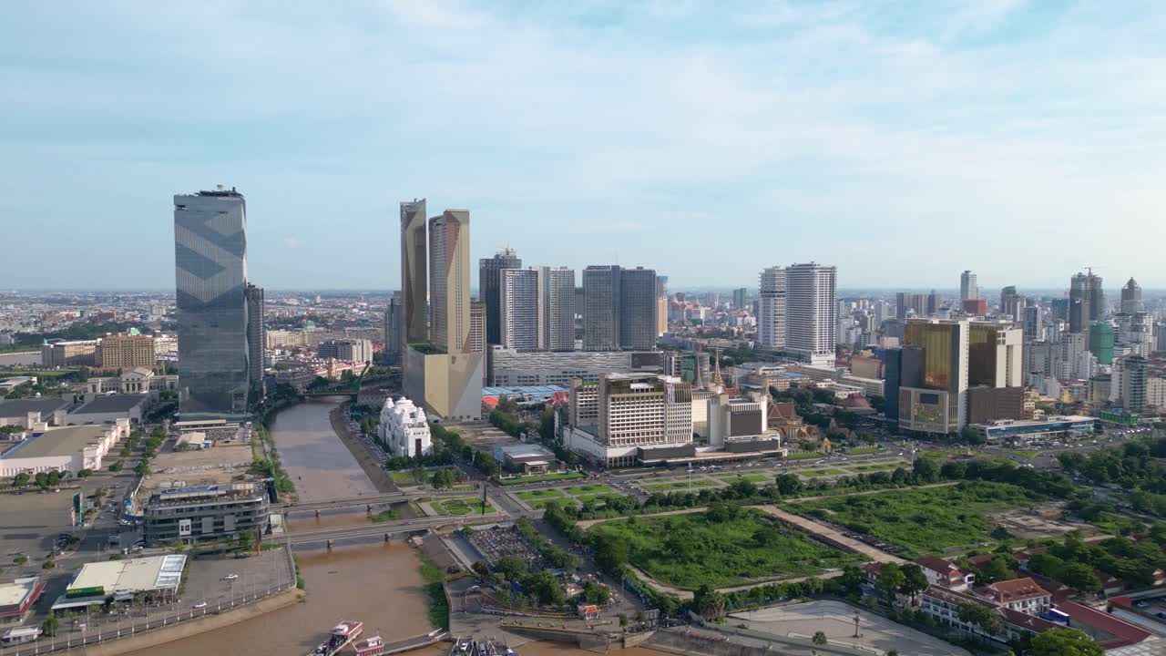 Drone shot of Phnom Penh city skyline, skyscrapers alongside Twin Dragon bridge on Tonle sap river