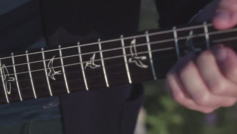 close-up of someone playing an electric guitar