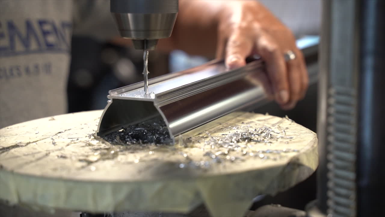 Close-up footage of person drilling a hole into what is to become a light fixture