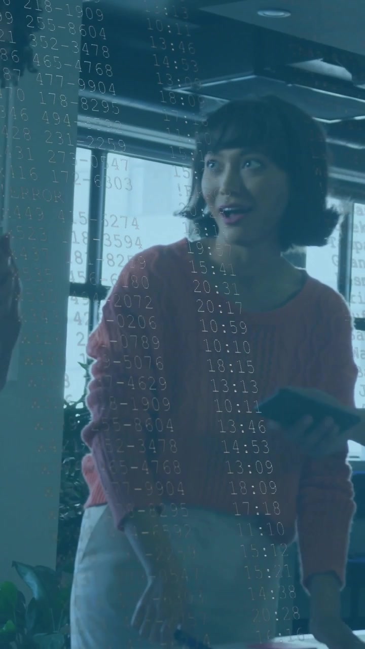 Vertical video: Woman pointing at docs, causing tech data overlay with red bar to fix issue