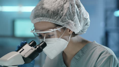 Portrait-of-Female-Scientist-in-Protective-Uniform-at-Work-in-Lab