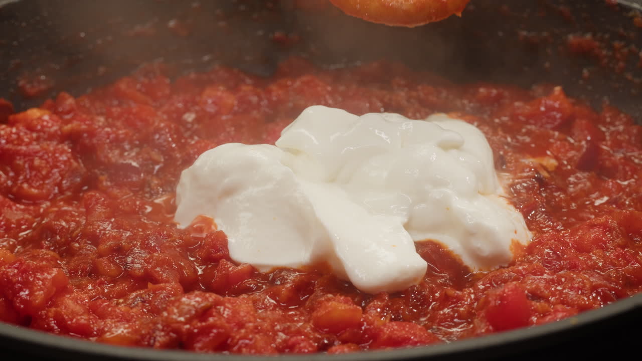 Cooking tomato sauce with cream