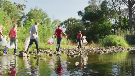 mid adults volunteering during river clean-up day