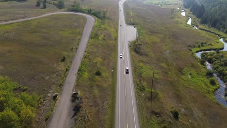 Aerial-View-Over-Cariboo-Highway-with-Traffic-Flowing-in-British-Columbia-near-127-Mile-House,-Canada