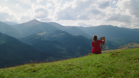 unknown woman painting masterpiece on green hill. girl drawing on easel outdoors