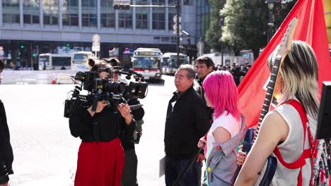 protesters with flags and camera crew in action