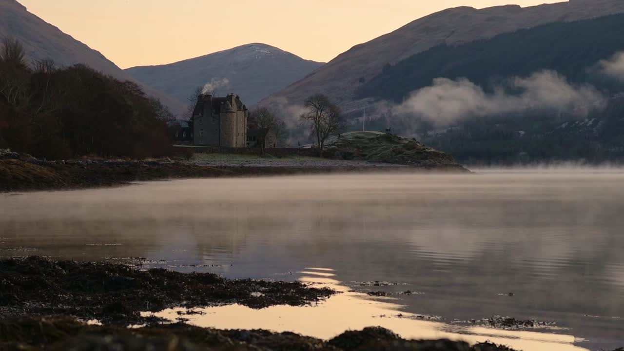 Dunderave Castle Between The Waters Of Loch Fyne And The Terrain Of Arrochar Alps In Argyll And Bute, Scotland. -wide shot