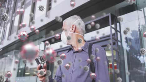animation of covid 19 cells over senior man wearing face mask