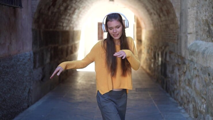 A young woman is joyfully dancing in a historic archway expressing her vibrant energy and spirit