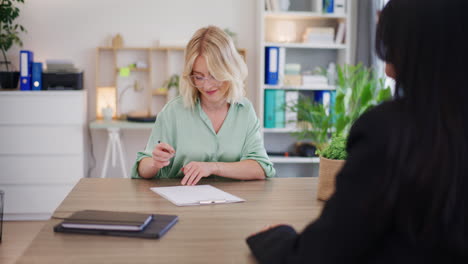 Young-Woman-Signs-Loan-Agreement