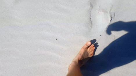 Top-View-Of-Man's-Feet-Walking-On-Sandy-Beach-Barefoot-Splashed-By-Sea-Waves