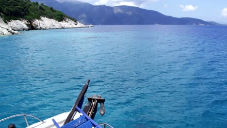 a boat sailing along the coast of ithaca in greece