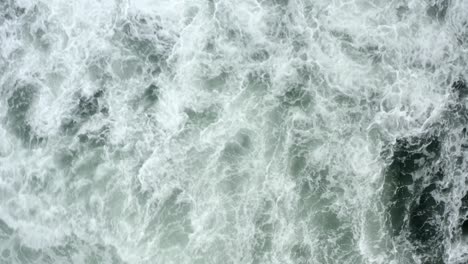 top view of foamy sea waves at tofino beach in british columbia, canada