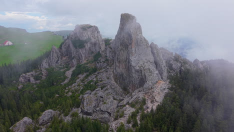 clouds partially covering the pietrele doamnei, a geological and touristic landmark in the rarau mountains, romania