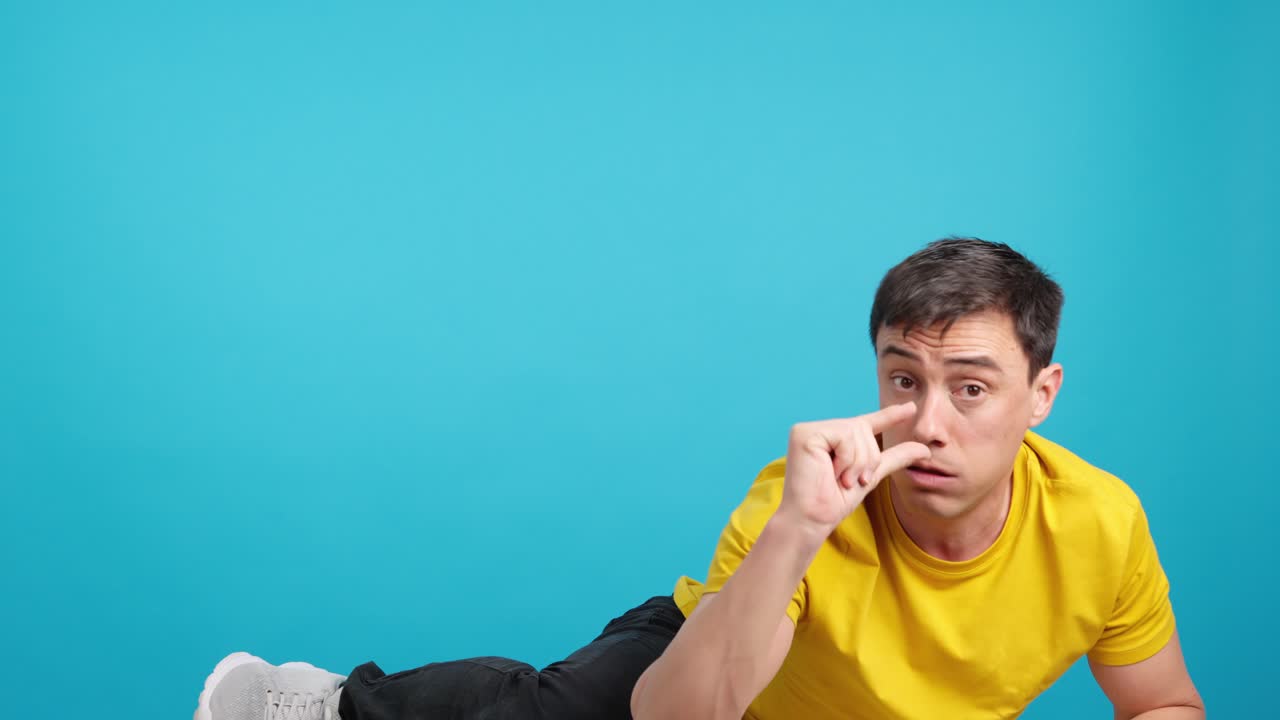 Man lying down pointing