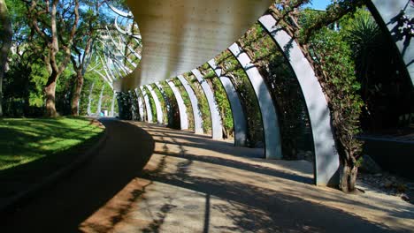 Sideway-Through-The-Curling-Galvanised-Steel-Posts-Of-The-Arbour-On-South-Bank-Parklands-In-South-Brisbane,-Australia