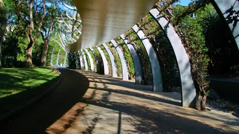 sideway through the curling galvanised steel posts of the arbour on south bank parklands in south brisbane, australia