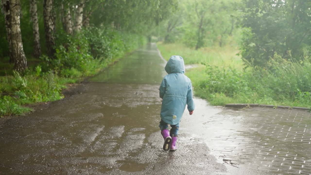 Kid revels in pleasure of play in rain happy child plays on wet terrain with carefree spirit