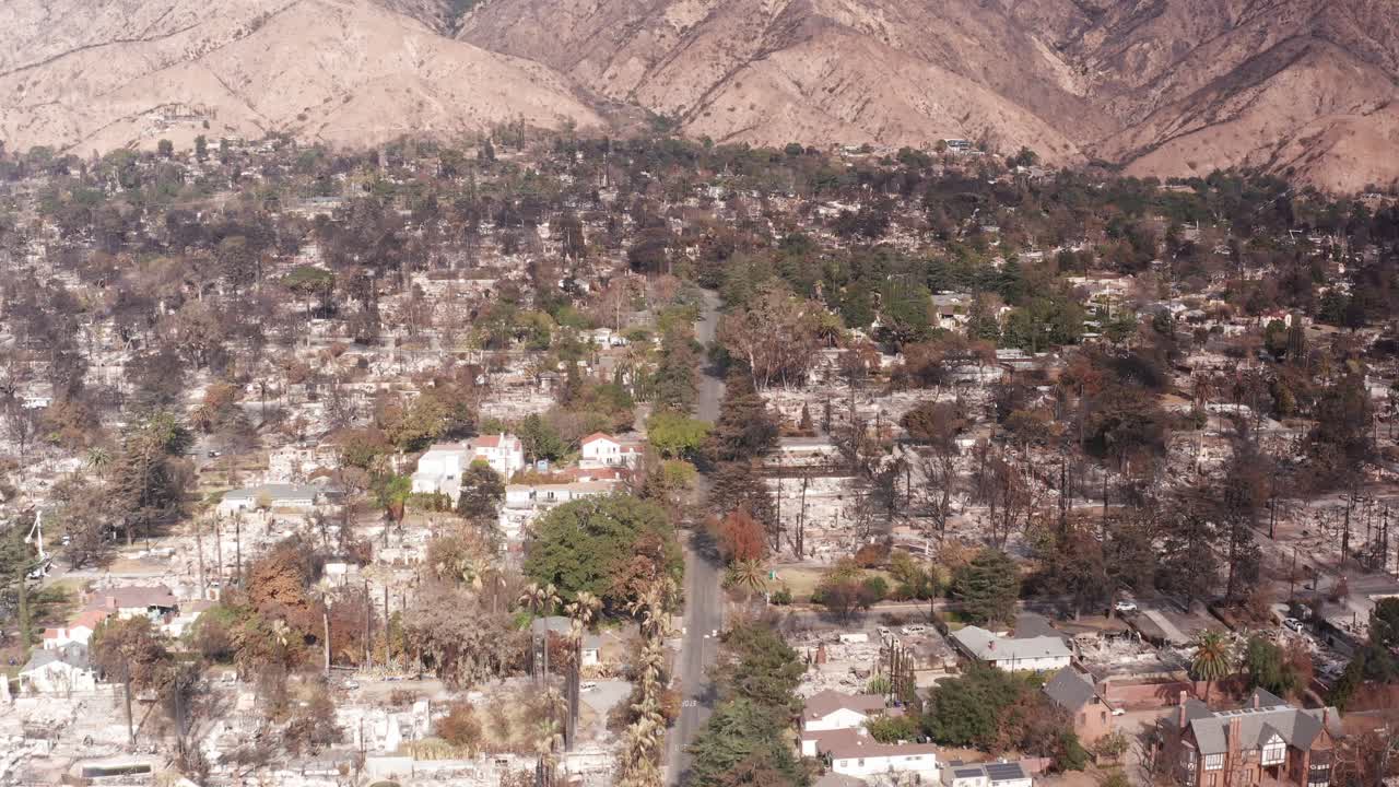 Low tilting up aerial shot of the charred landscape in the Eaton Fire burn scar in Altadena, California. 4K