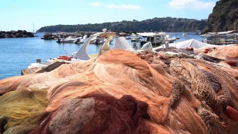 pan shot of fishing nets on the harbor pier in procida island, corticella area along the neighborhood in bologna, italy on a sunny day