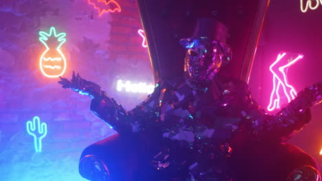 a man in a steel silver metal suit sits in a chair and shakes his head to music in the neon light. she spreads her arms and dances.