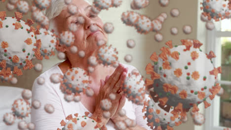 Covid-19-cells-moving-against-senior-woman-praying