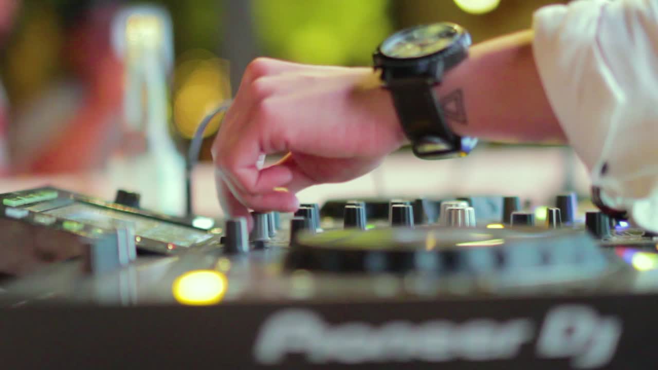 The DJ is playing music in a party.