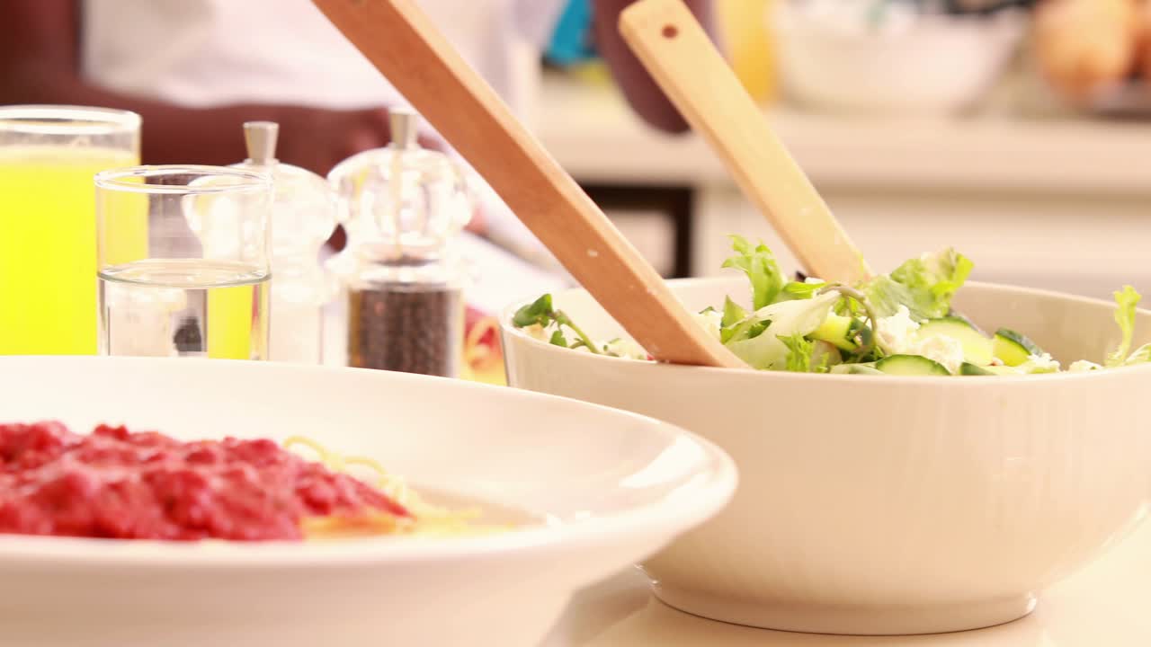 Floating icons appearing above plates, diners cutting salad, twirling pasta showing online interest