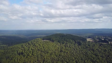 Aerial-footage-flying-towards-Blue-Mountain-with-a-fire-tower,-near-Newbury,-central-Victoria,-Australia