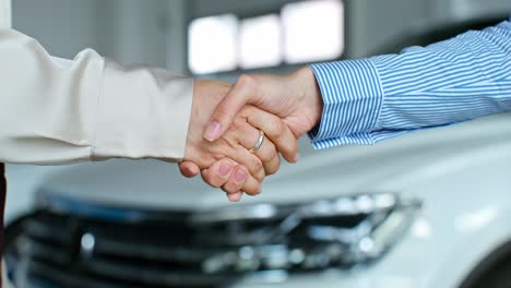 business handshake in a car dealership