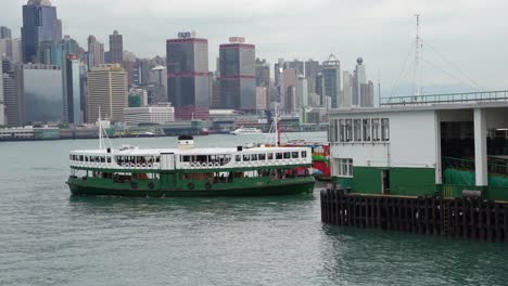 ferry sails along the deep ocean waters at tsim sha tsui waterfront, hong kong