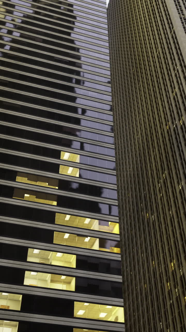 Modern skyscrapers illuminate the urban skyline at dusk in the city