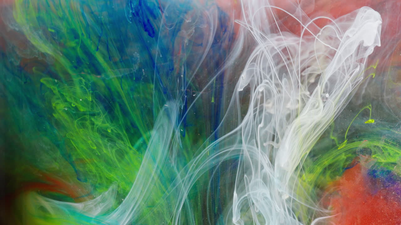 Vibrant inks mixing in water, creating colorful abstract patterns, macro view