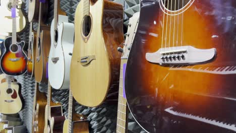 shop with acoustic guitars. different types of guitars.