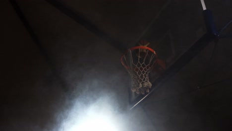 sportsman dunking basketball in hoop