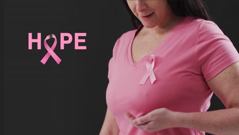 Animation-of-hope-text-over-caucasian-woman-with-pink-ribbon-on-black-background