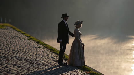 vintage couple by the river at sunrise