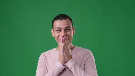 astonished man over green background