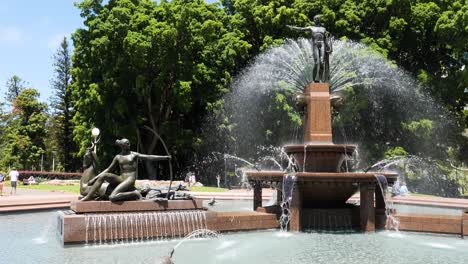 stunning bronze statues and fountain in a lush green park