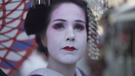 a closeup shot of a geisha looking out into the distance in kyoto, japan