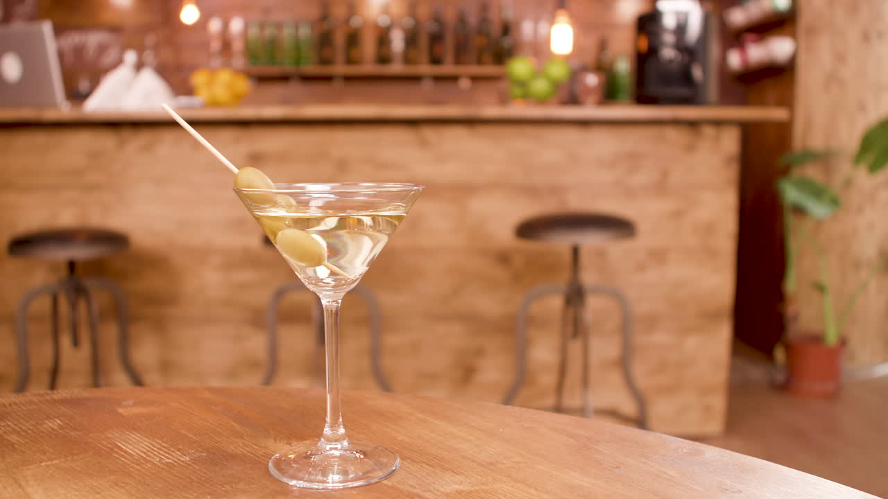 Martini with Olives at a Bar