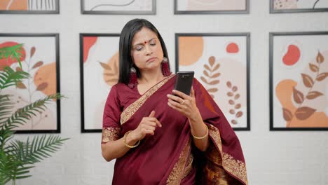 Bored-Indian-woman-scrolling-phone