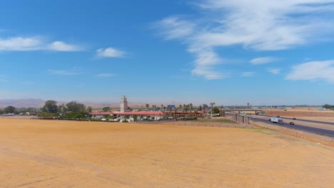 Aerial-Of-Spanish-Themed-Rest-Stop-At-Santa-Nella-Along-Highway-5-Through-Central-California