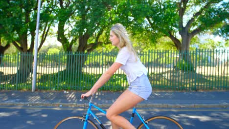 Woman-riding-a-bicycle-in-the-street-4k